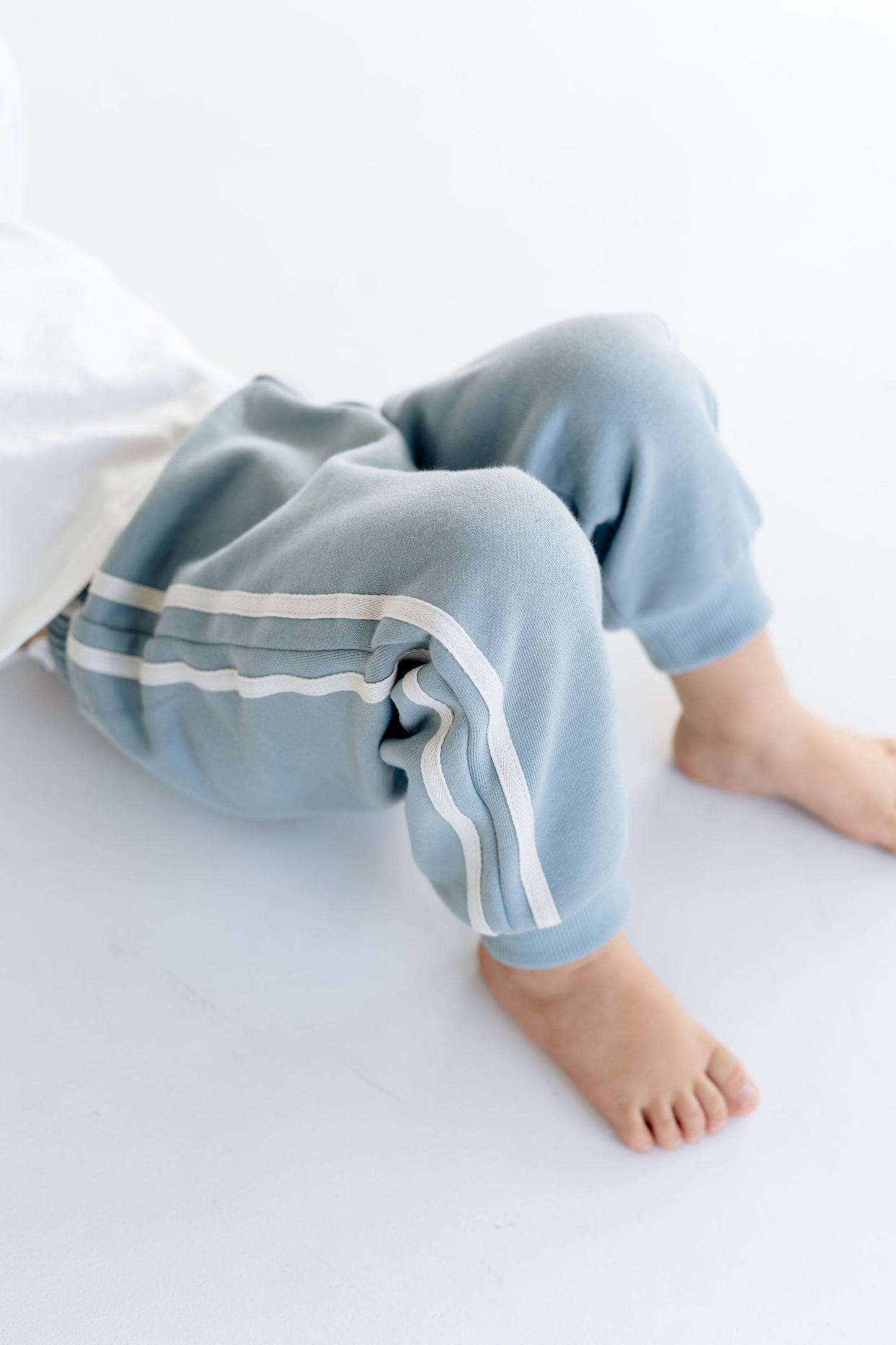 Boys blue tracksuit pants, elasticated waistband, grey racer stripes